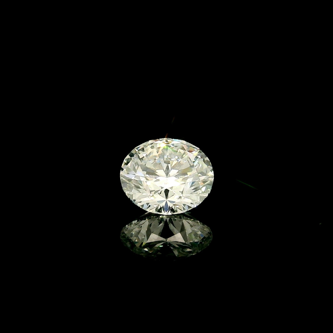 A 1.5 ct. Round Cut Lab Grown Diamond reflecting on a black surface.