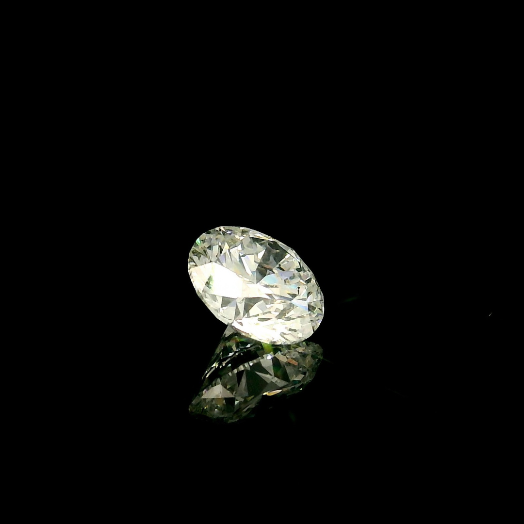 A 1.5 ct. Round Cut Lab Grown Diamond reflecting on a black surface.