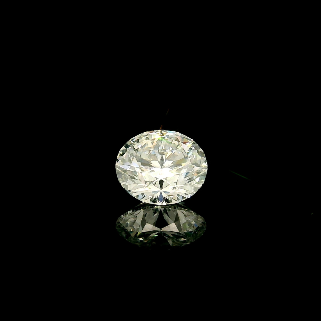 A 1.5 ct. Round Cut Lab Grown Diamond centered against a black background with a reflection beneath it.