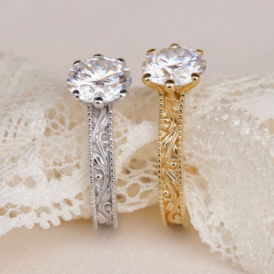 Two diamond rings, one gold and one silver, on a lace fabric background.