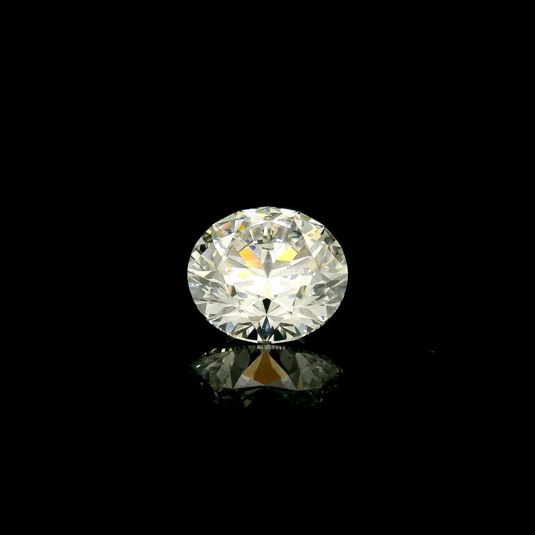 A 2 ct. Round Cut Lab Grown Diamond reflecting on a black surface.