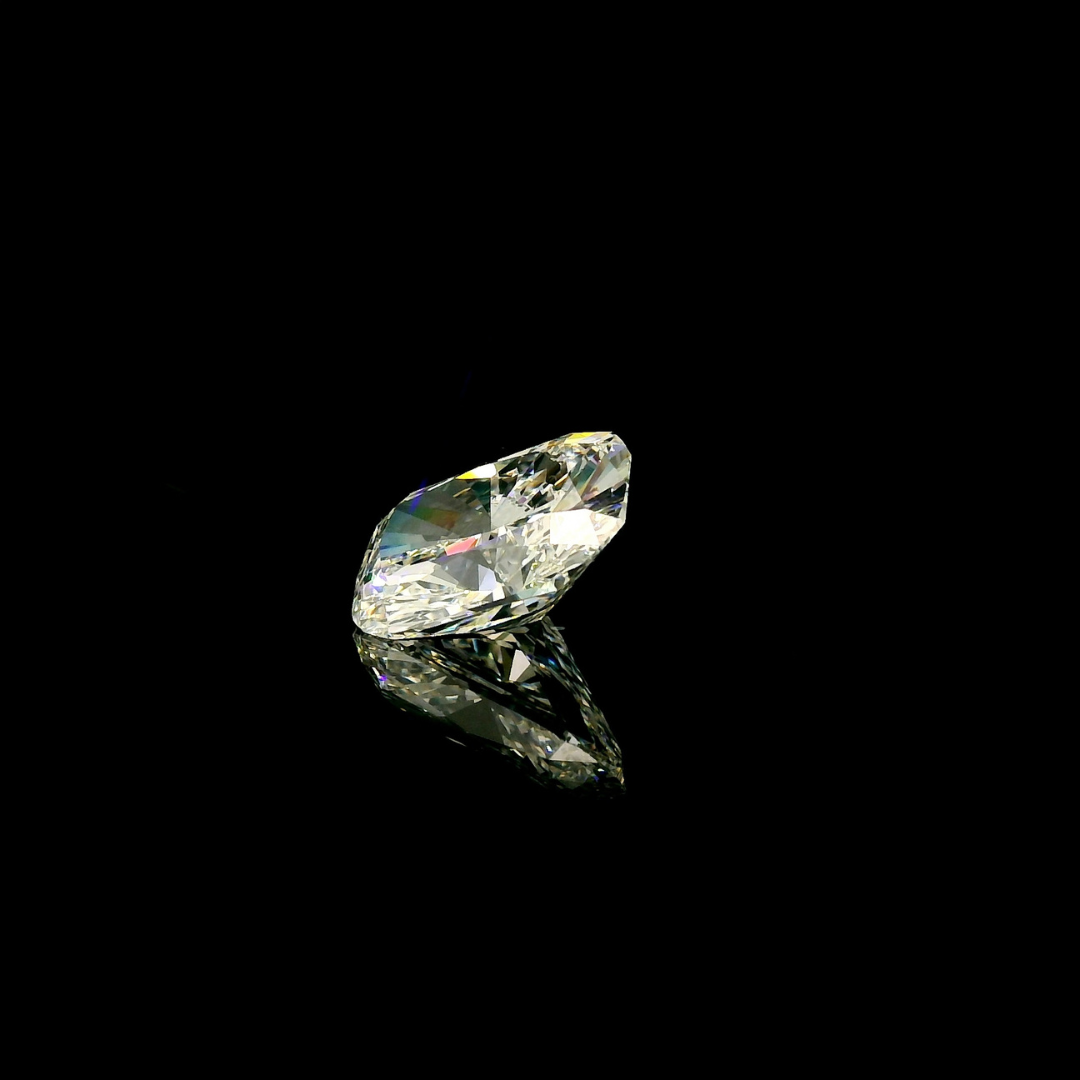 3 ct. Elongated Cushion Cut Lab Grown Diamond reflecting on a black surface.
