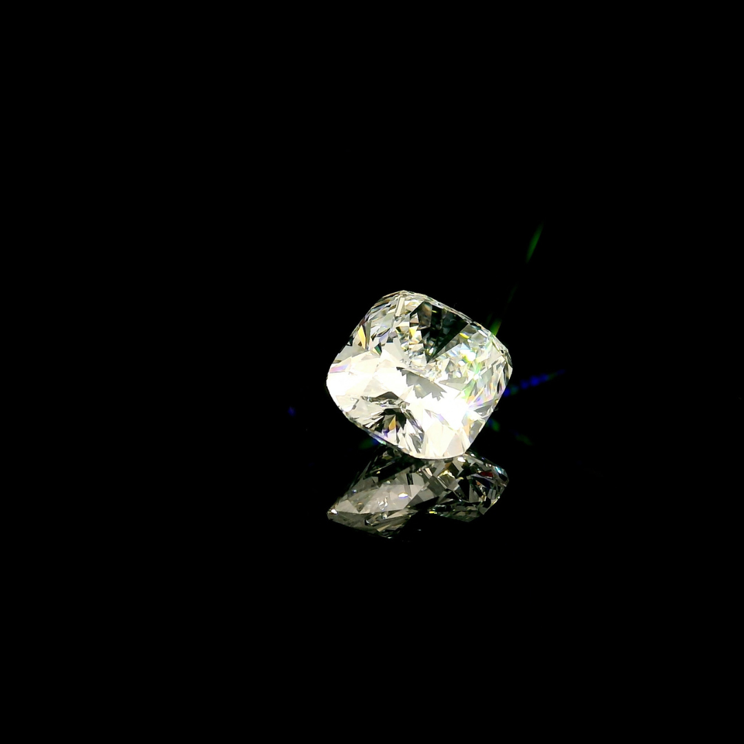 A 3 ct. Elongated Cushion Cut Lab Grown Diamond reflecting on a black surface.