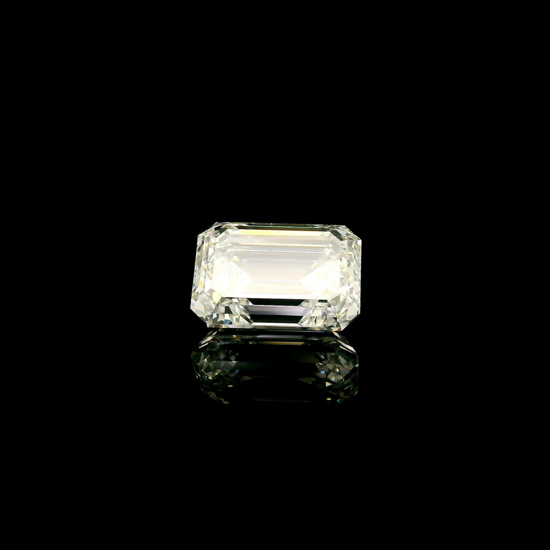 A 3 ct. Emerald Cut Lab Grown Diamond shown against a black background with a visible reflection below it.