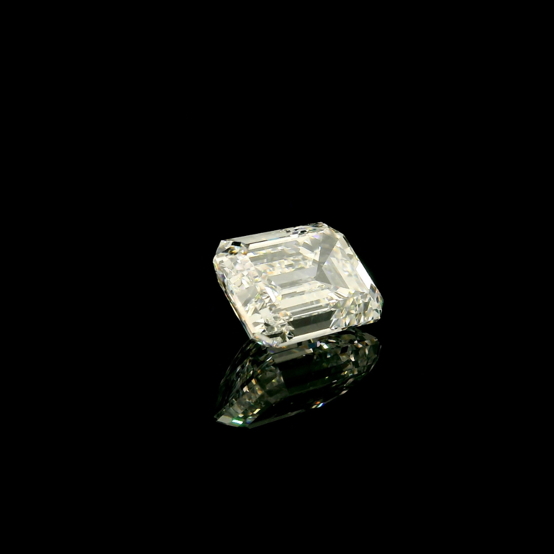 A 3 ct. Emerald Cut Lab Grown Diamond with an emerald-cut shape set against a black background with a visible reflection.