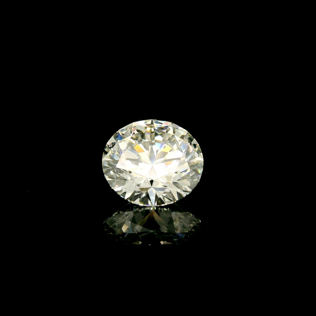 A 3 ct. Round Cut Lab Grown Diamond centered on a black reflective surface.