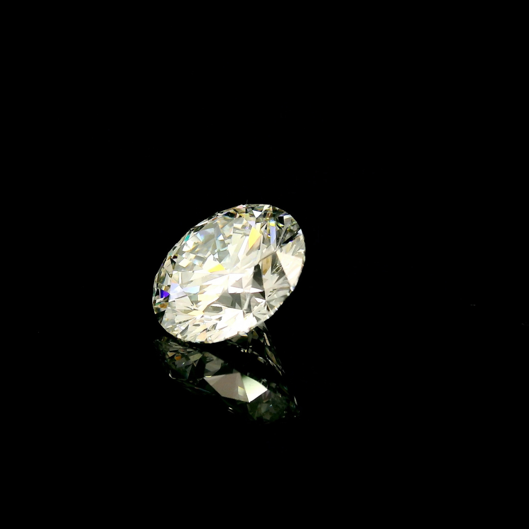 A 3 ct. Round Cut Lab Grown Diamond with VVS2 clarity reflecting on a black surface.