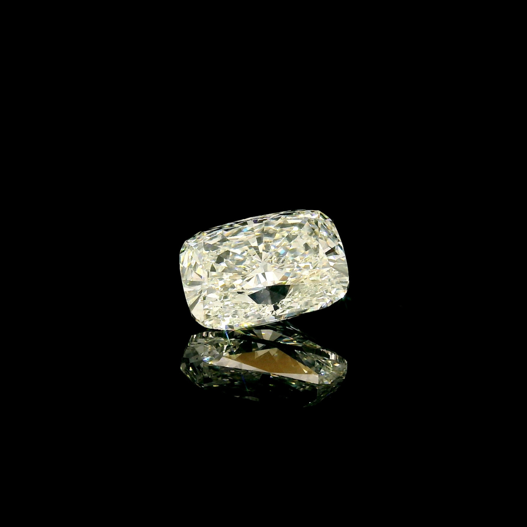 A 4 ct. Elongated Cushion Cut Lab Grown Diamond set against a black background with a reflection below.