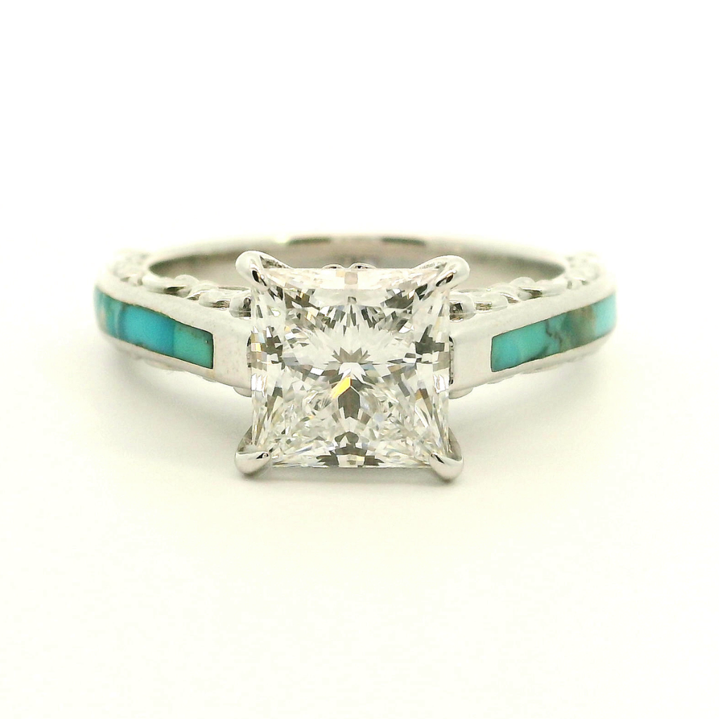 The Diamond Emory is a silver lab-grown diamond ring featuring a large square-cut center stone and striking turquoise inlay accents along the band, displayed against a plain white background.