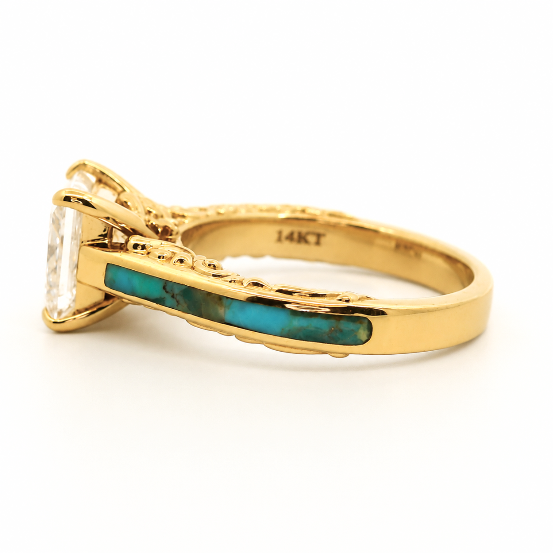 The Diamond Emory is a gold ring featuring a striking turquoise inlay on the band and a large clear gemstone set in a raised setting. The inside of the band is marked 14KT.