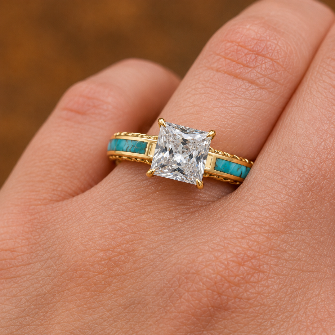 A hand wearing the Diamond Emory, a Western-inspired gold lab-grown diamond engagement ring, featuring a large square-cut clear gemstone and stunning turquoise inlay along the band.