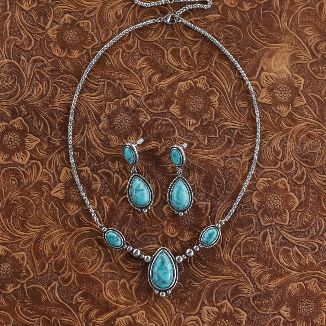The Kay Drop Earrings and a matching silver chain necklace featuring teardrop-shaped turquoise stones set in ornate silver settings.