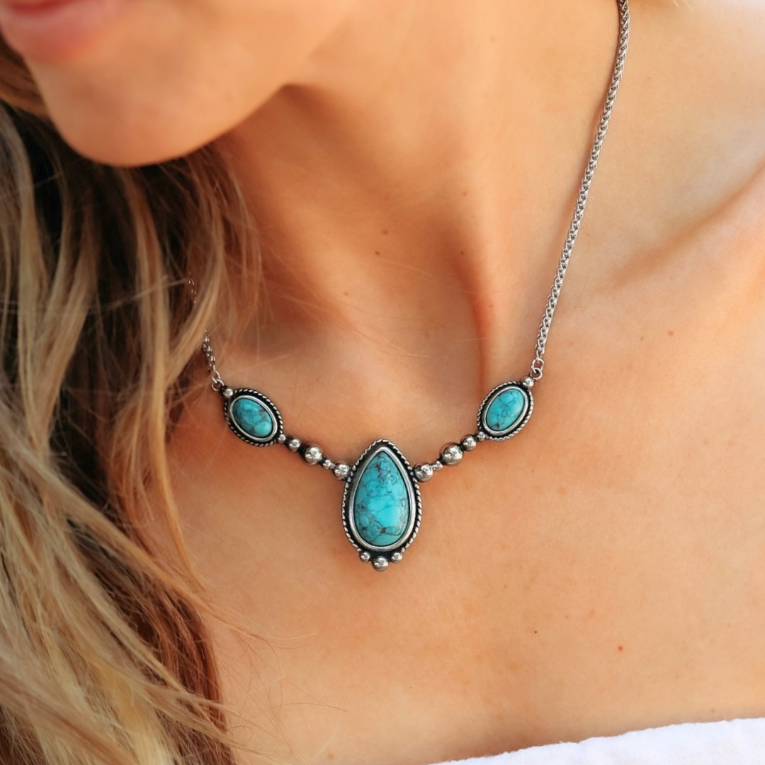 The Kay silver Western necklace featuring a large teardrop-shaped turquoise pendant flanked by two smaller oval turquoise stones.